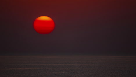 timelapse shot of golden sunset going down behind ocean water at dusk in the evening - close up