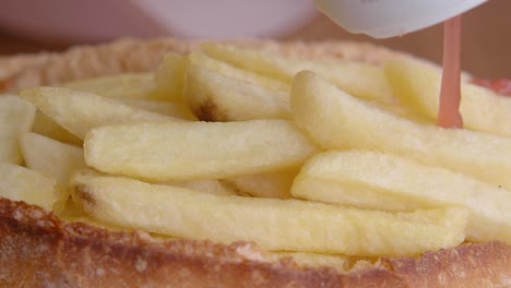 fries being added to a sandwich