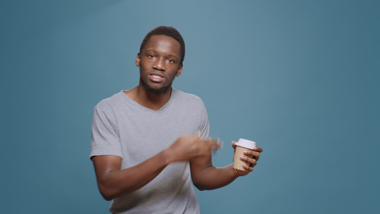 Cheerful man enjoying cup of coffee to refresh in the morning