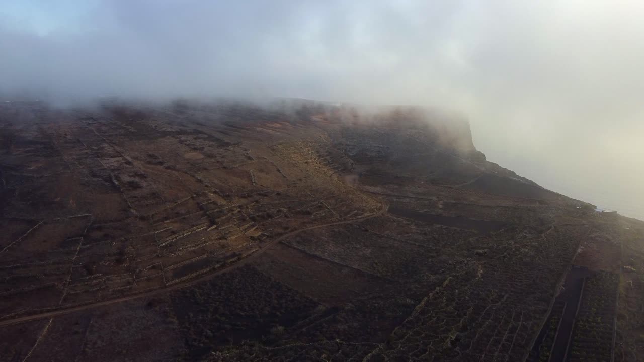 Panorama Of The Agricultural Landscape Of La Corona Volcano Under Feathery Clouds In Lanzarote, Spain. aerial