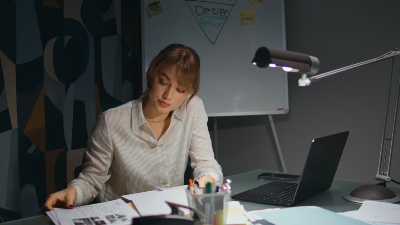 Exhausted office worker overworking late room closeup. Girl flipping documents