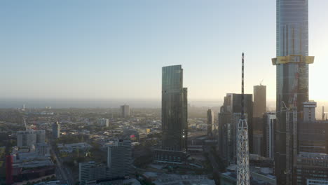 Static-aerial-perspective-looking-out-toward-Port-Philip-Bay-while-traffic-moves-along-the-arterial-surrounding-Melbourne,-Australia-on-a-glorious-afternoon