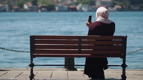 woman taking photo by the river