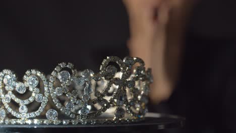 beauty pageant queen or bride looks up to see the jewel crown of her dreams with diamonds, pearls and silver