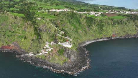 dramatic setting of farol ponta do arnel lighthouse in são miguel island, aerial