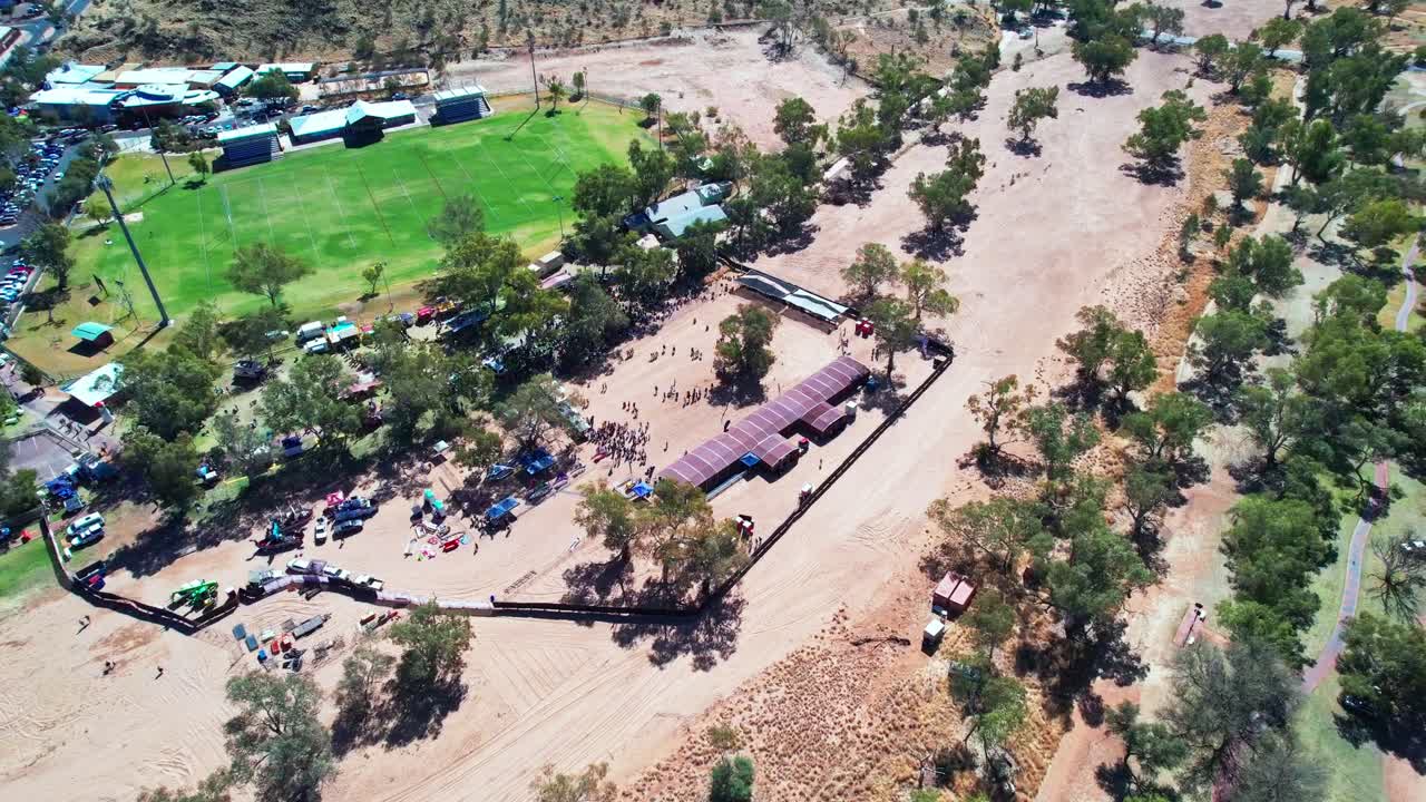 Circling aerial footage of Henly on Todd Regatta on the dry river bed of the Todd River, Alice Springs, Mparntwe. Northern Territory, Australia. August 2022.