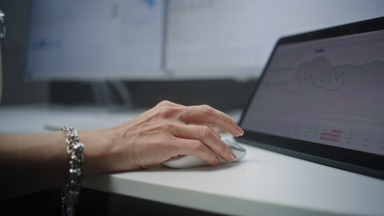 Female Stock Broker Using Computer Mouse, Analyzing Real-Time Stocks, Exchange Market Charts on Tablet Computer and Digital Screens. Investment Agent Working in Financial Agency Office. Close Up.