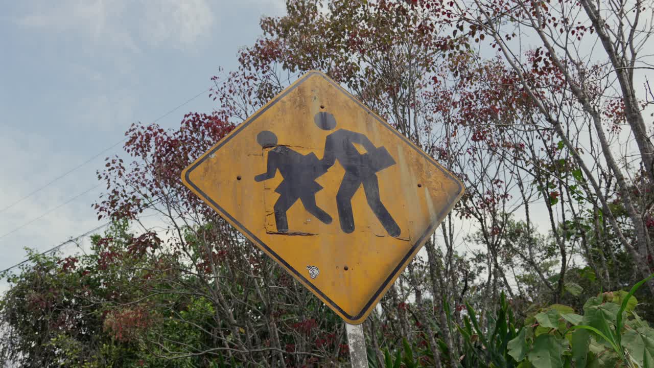 School crossing sign, warns drivers to be cautious because children might be crossing the road