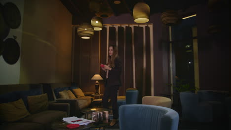 business woman waiting for meeting in hotel lounge at evening