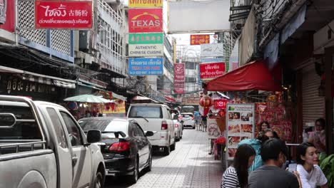 cars and pedestrians in a busy market street