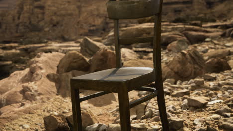 chair placed in a rocky desert landscape during bright daylight