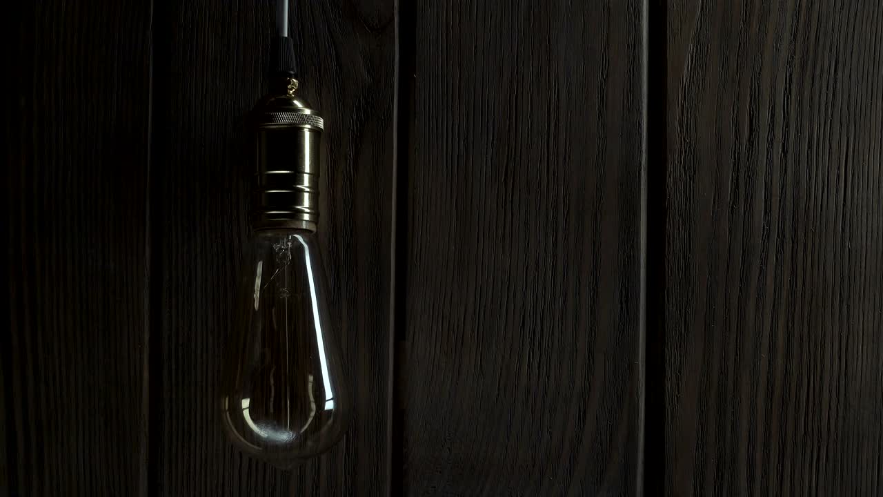 light bulb illuminates on wooden background