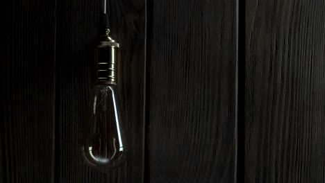 light bulb illuminates on wooden background