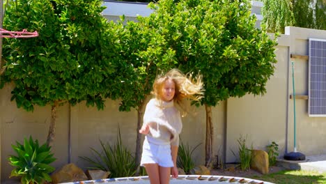 girl jumping on a trampoline in the garden 4k