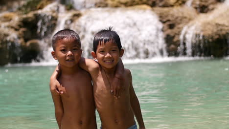 two boys at a waterfall