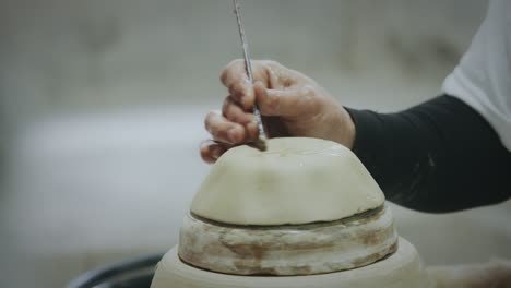 slow motion, master potter creating ceramic products from white clay