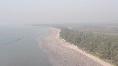 Hoher-Drohnenschuss-über-Leerem-Sandstrand-An-Einem-Dunstigen-Tag