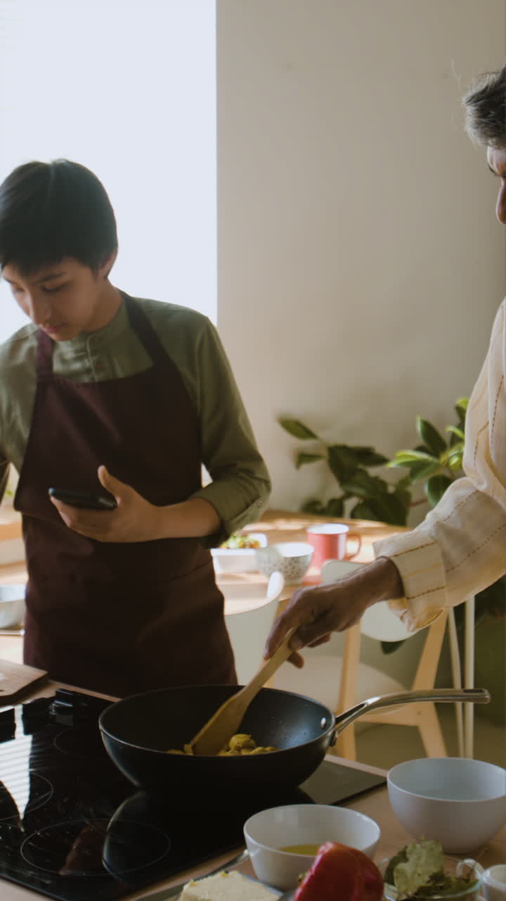 Father and Son Cooking Together in the Kitchen