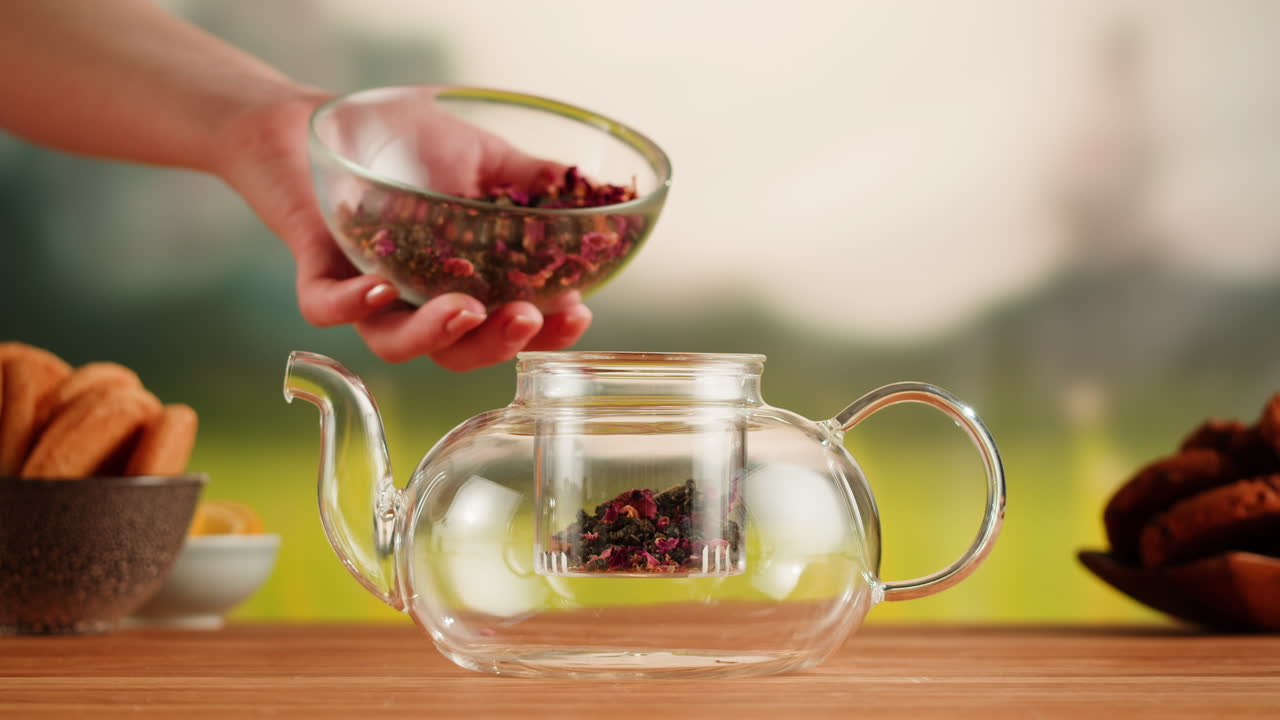 Preparing Herbal Tea in a Glass Teapot