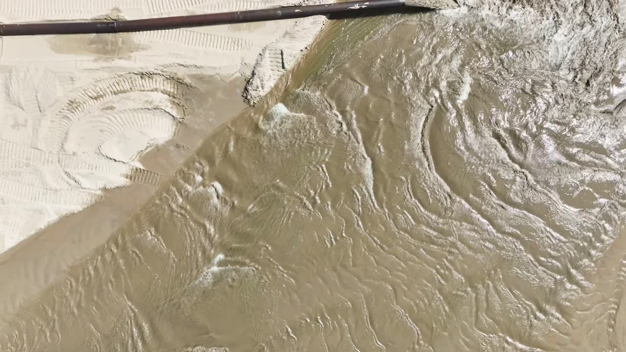 Water lapping against the newly dredged shoreline of Lake Michigan