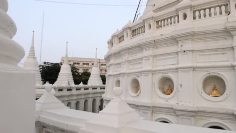 a serene view of wat prayurawongsawat's white pagoda in bangkok, showcasing intricate architecture under a clear sky