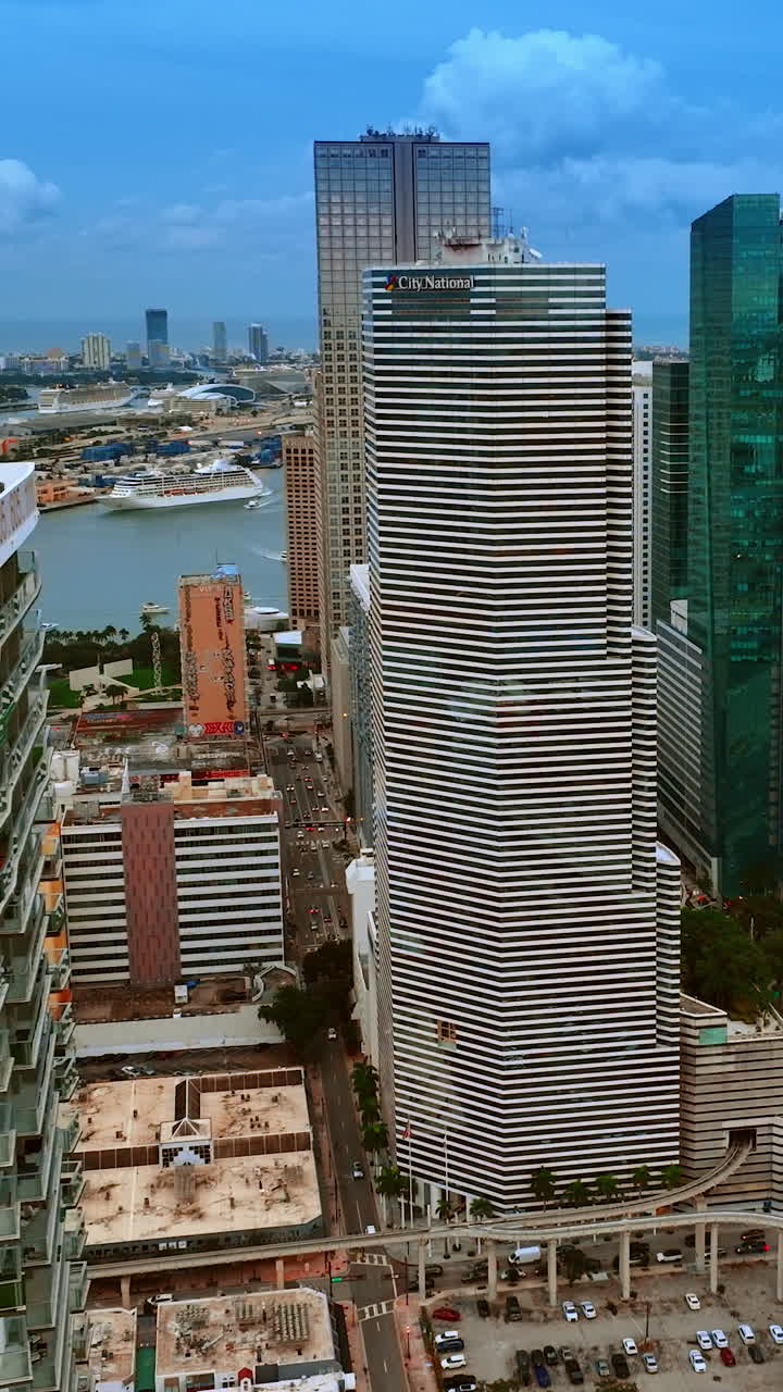 Blocks of flats and office buildings in Miami downtown, Florida, USA. View on the waterscape from top. Vertical video
