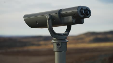 Visitor-telescope-looking-over-tundra-landscape