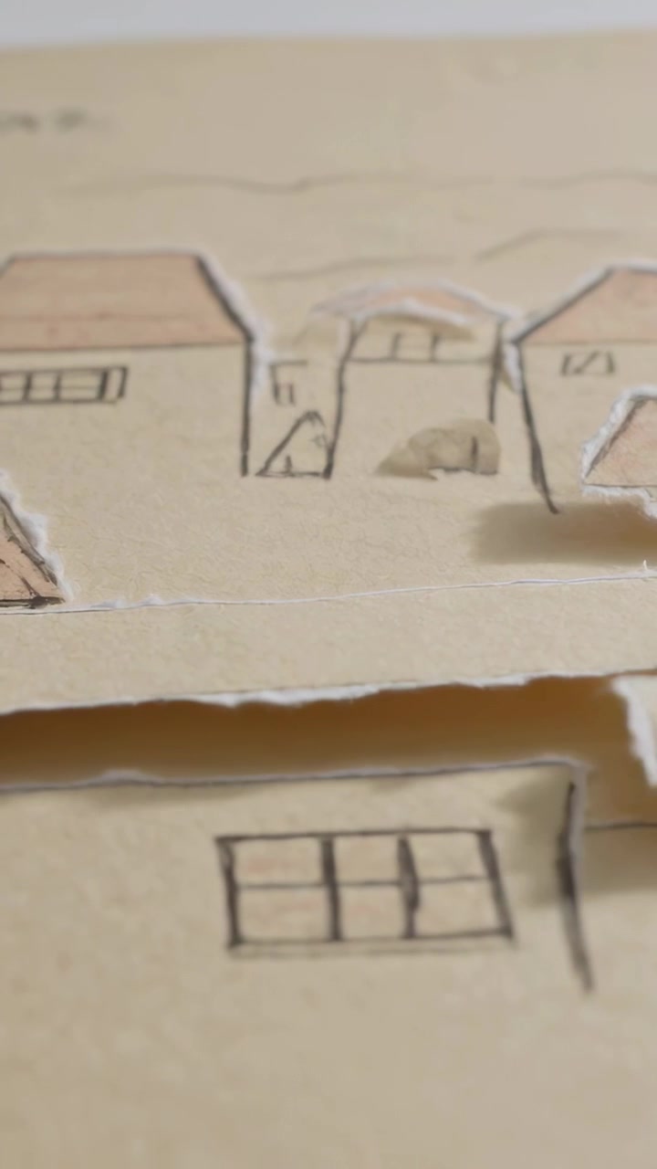 Vertical video: Panning camera showing pop-up town on desk tip casting shadow, moving drawn windows