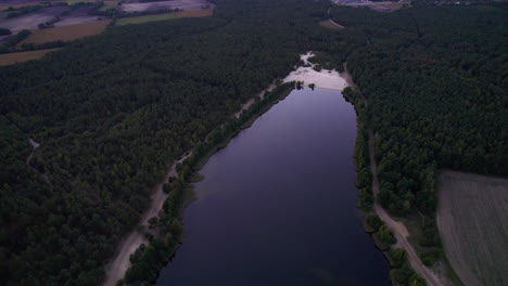 aerial view of lake in the middle of the forest