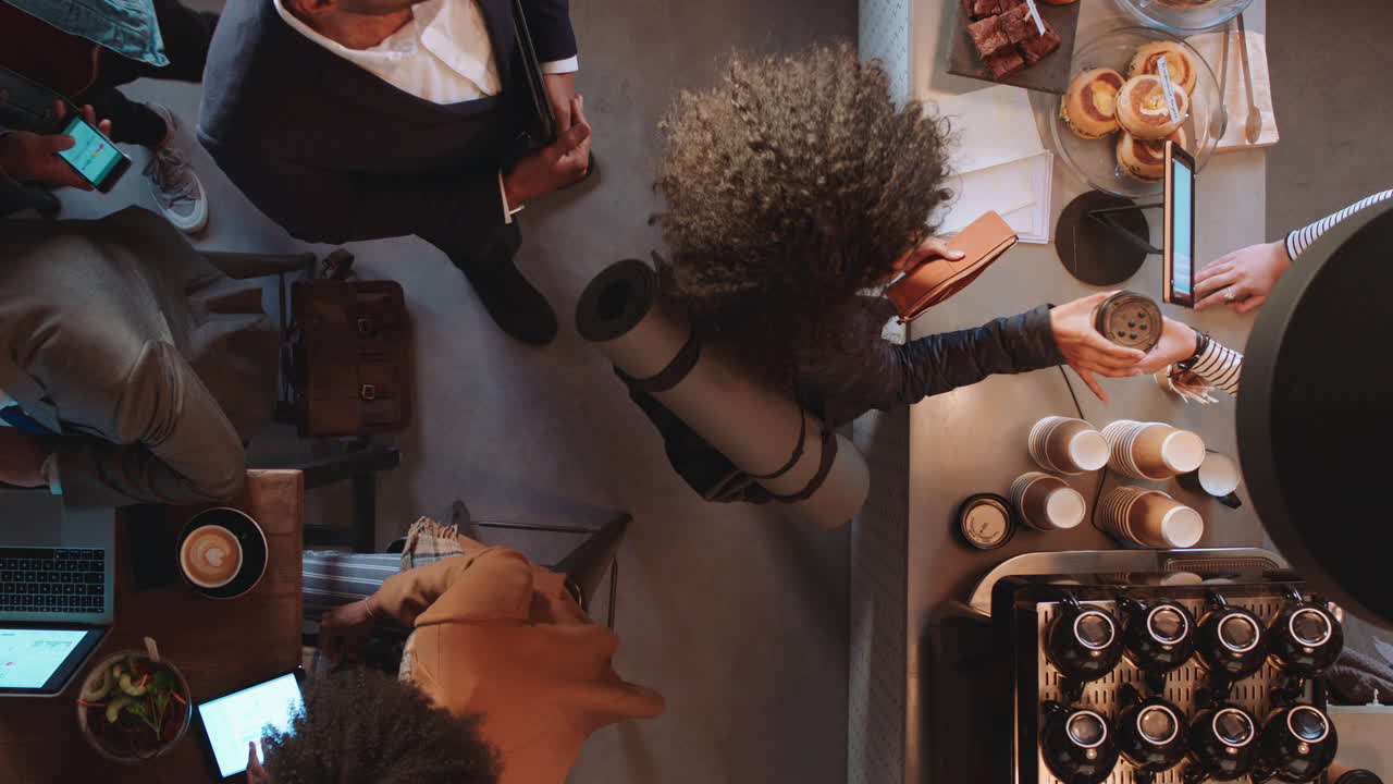 top view customers buying coffee making payment using card machine enjoying service in cafe