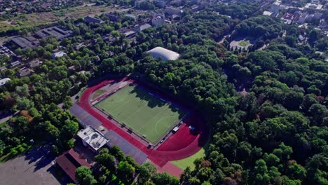 buildings with street in small town with empty football soccer field