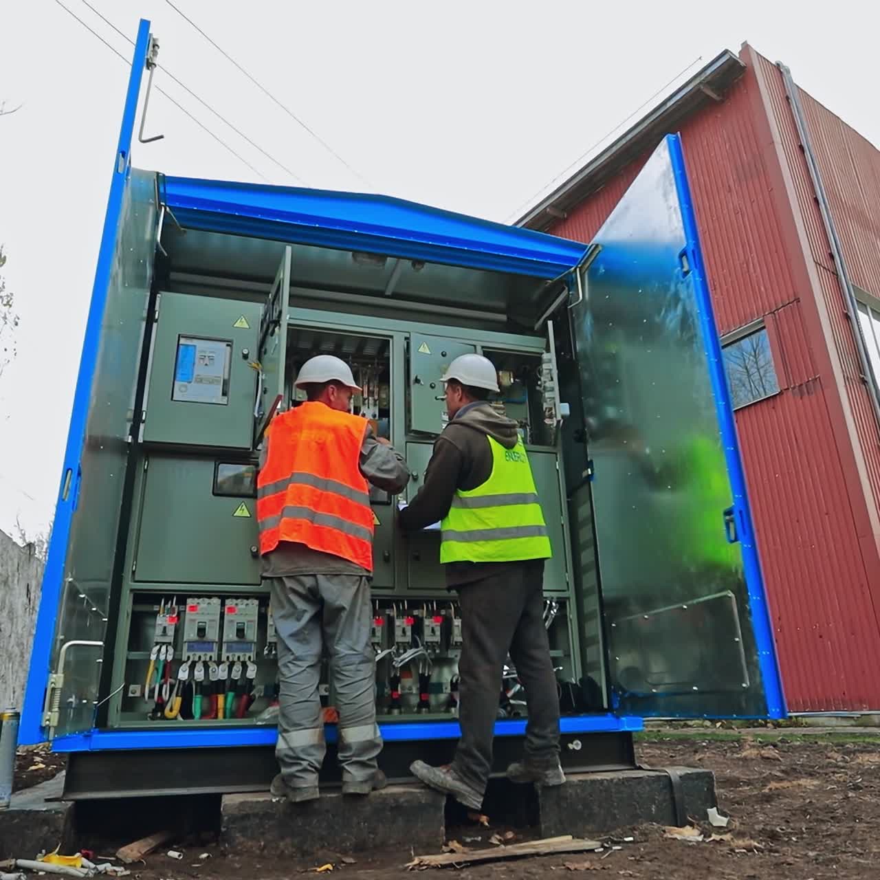 Electricians testing electrical power. Industrial factory electrician testing voltage on the solar power plant. Operation and maintenance of electrical system.