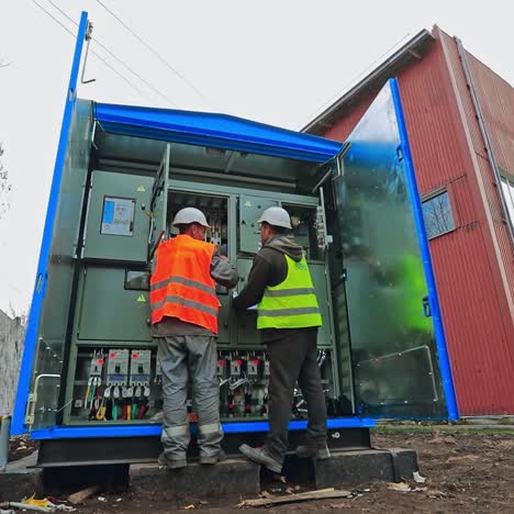 electricians testing electrical power. industrial factory electrician testing voltage on the solar power plant. operation and maintenance of electrical system.
