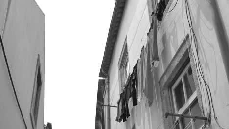 Clothes-hanging-on-a-clothesline-outside-an-apartment-in-Porto,-Portugal