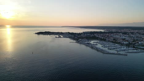 Aerial-over-marina-and-sunset-over-Adriatic-in-Zadar,-Croatia