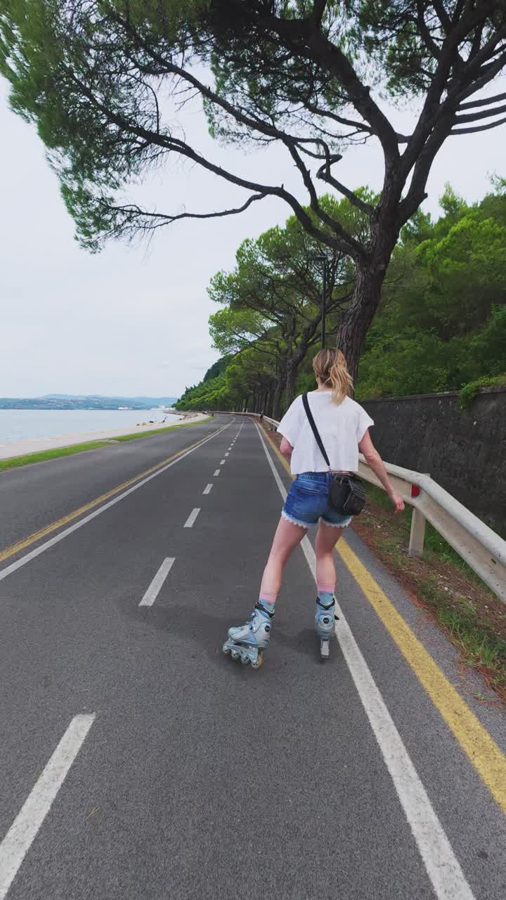 Woman blading along coastal trail connecting Koper and Izola, vertical shooting