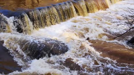 waterfall rushing into the creek after a strong rainstorm