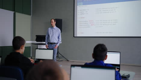 teacher presenting a programming lesson in a classroom