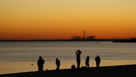 people enjoying sunset at st kilda beach