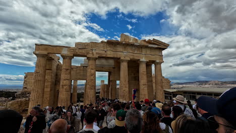 tourists visiting the propylaea at the acropolis of athens