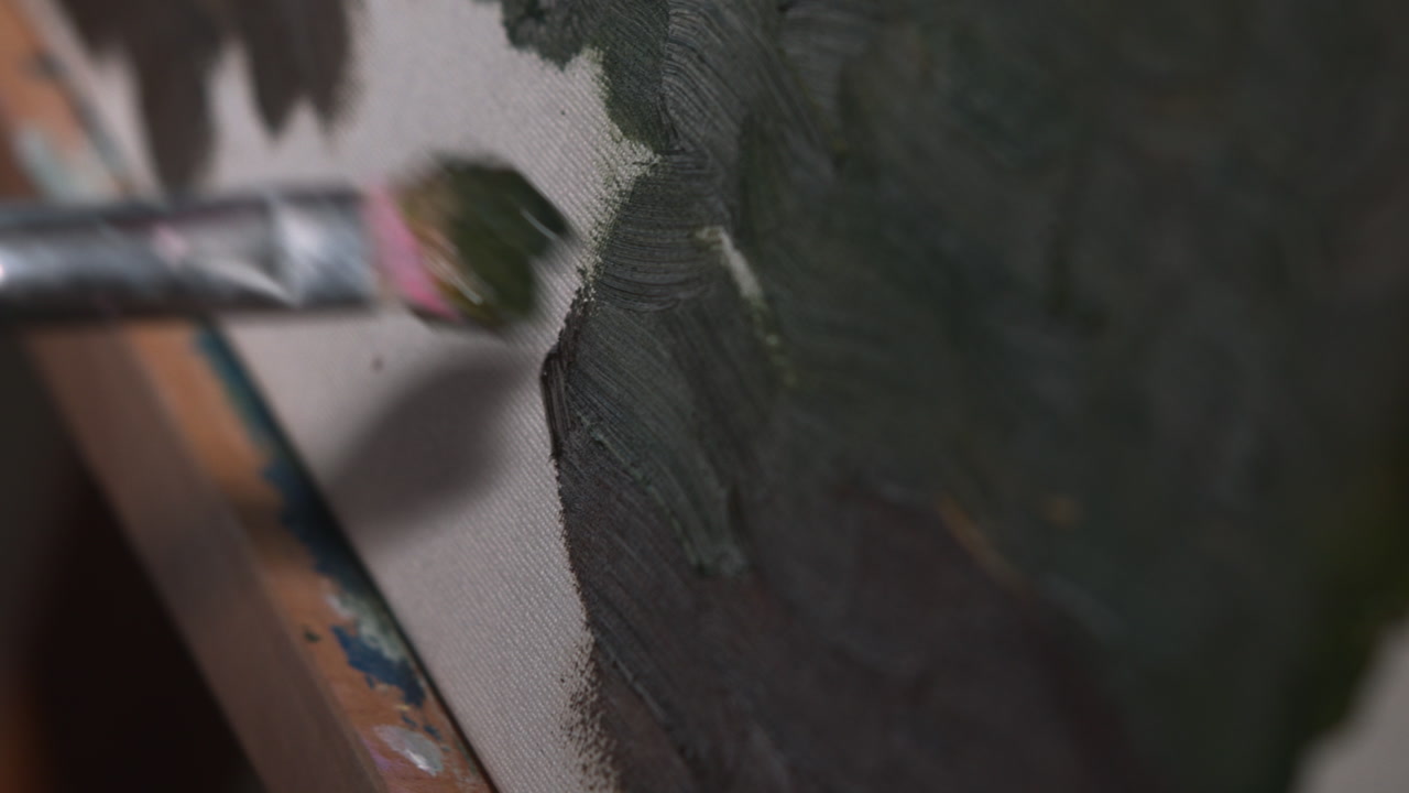 Caucasian Art Therapist Applying Deep Green Texture On Canvas Closeup, Soft Brush Dabbing Earthy Pigment Into . Media