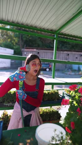 woman watering plants at a garden market