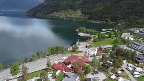 aerial view from the town of kinsarvik norway with hardangerfjord on a sunny day and ferry arriving in the distant