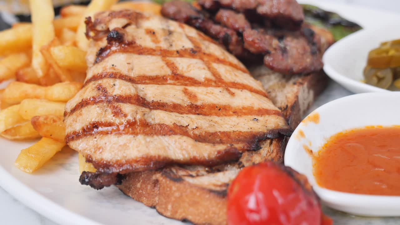 Grilled chicken with fries, meat and sauce