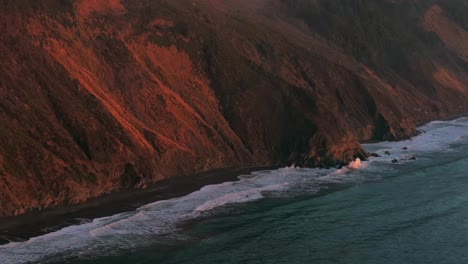 usal beach campground northern california aerial drone bluffs cliffside mountain rocky rugged remote coast vibrant sunset sinkyone wilderness waves crashing surf swell circle right motion