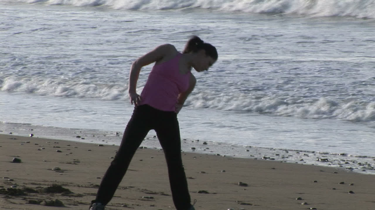 Woman Stretching on Beach