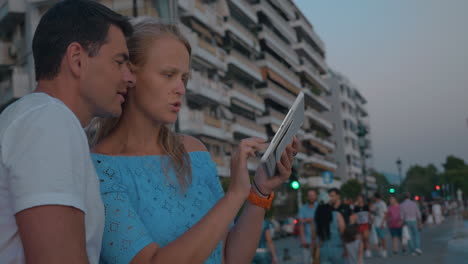 Couple-using-tablet-computer-outdoor-on-resort