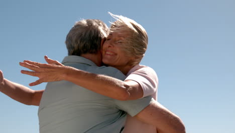 senior couple hugging on sunny day