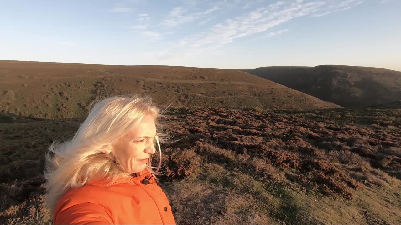 Blonde woman on top of hills at sunrise, Church Stretton, Long Mynd, Shropshire Hills