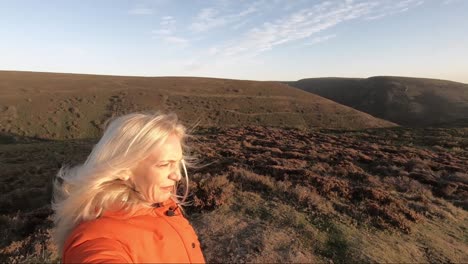 blonde woman on top of hills at sunrise, church stretton, long mynd, shropshire hills